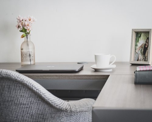 Person doing light stretching exercises at a standing desk in home office